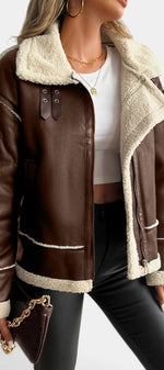 Mahaute brown faux leather aviator jacket with cream shearling collar, zip closure, and buckle straps.
