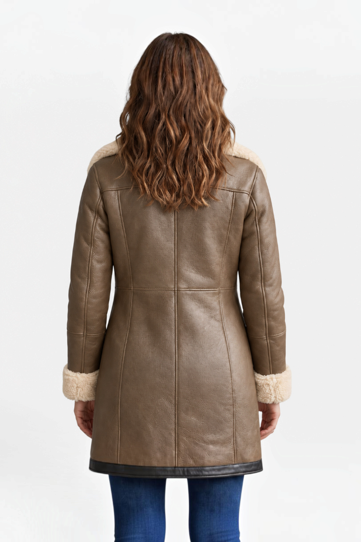 Back view of a woman wearing a Mahaute Hildegarde mid-length brown faux leather coat with cream faux fur trim.