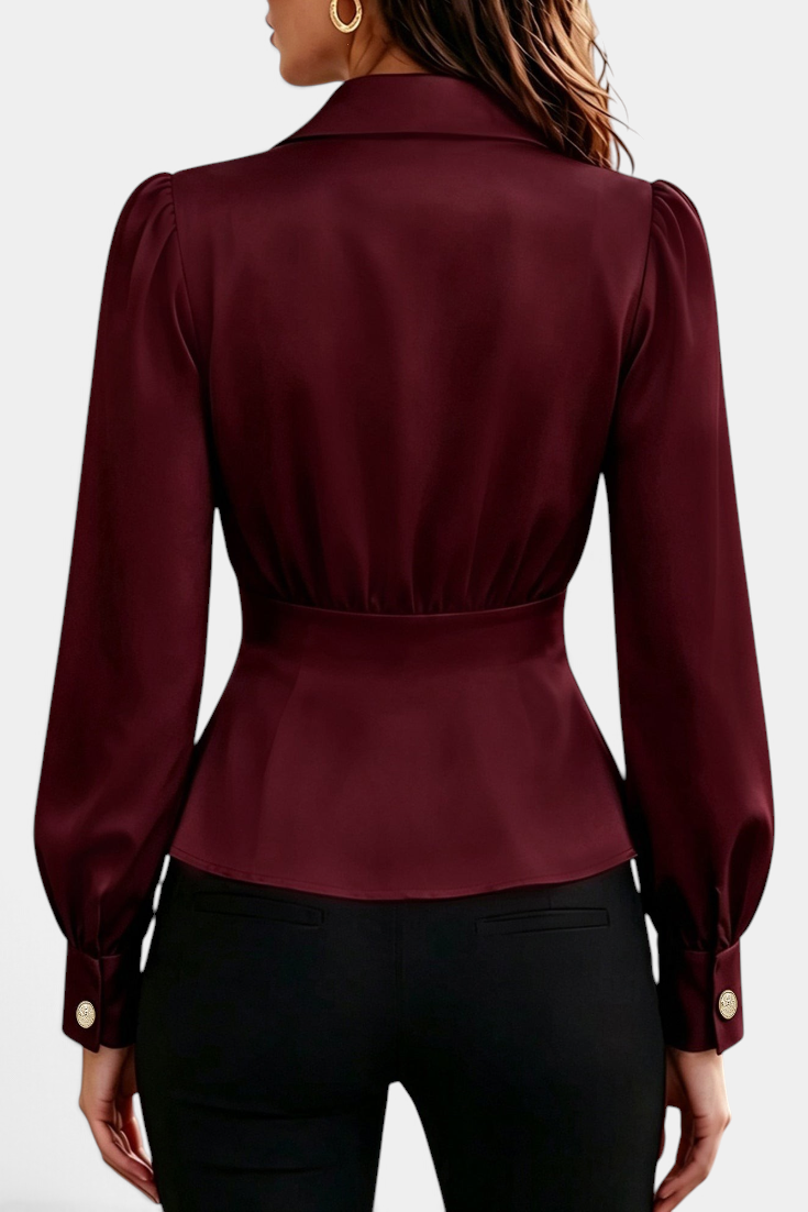 Mahaute burgundy long-sleeve blouse with tailored collar, cinched waist, and gold button cuffs, back view.