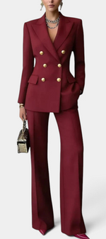 Mahaute Nadezhda burgundy double-breasted blazer and wide-leg trouser suit with gold buttons for formal occasions.