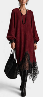 Mahaute Simona long burgundy knit dress with black floral lace trim, V-neck, voluminous sleeves, and asymmetric hem.