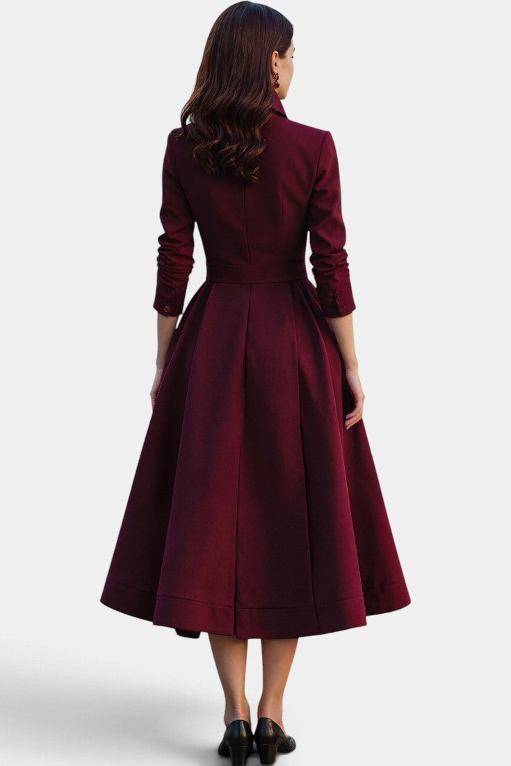Back view of a Mahaute burgundy midi dress with a structured high collar, cinched waist, and flared skirt.