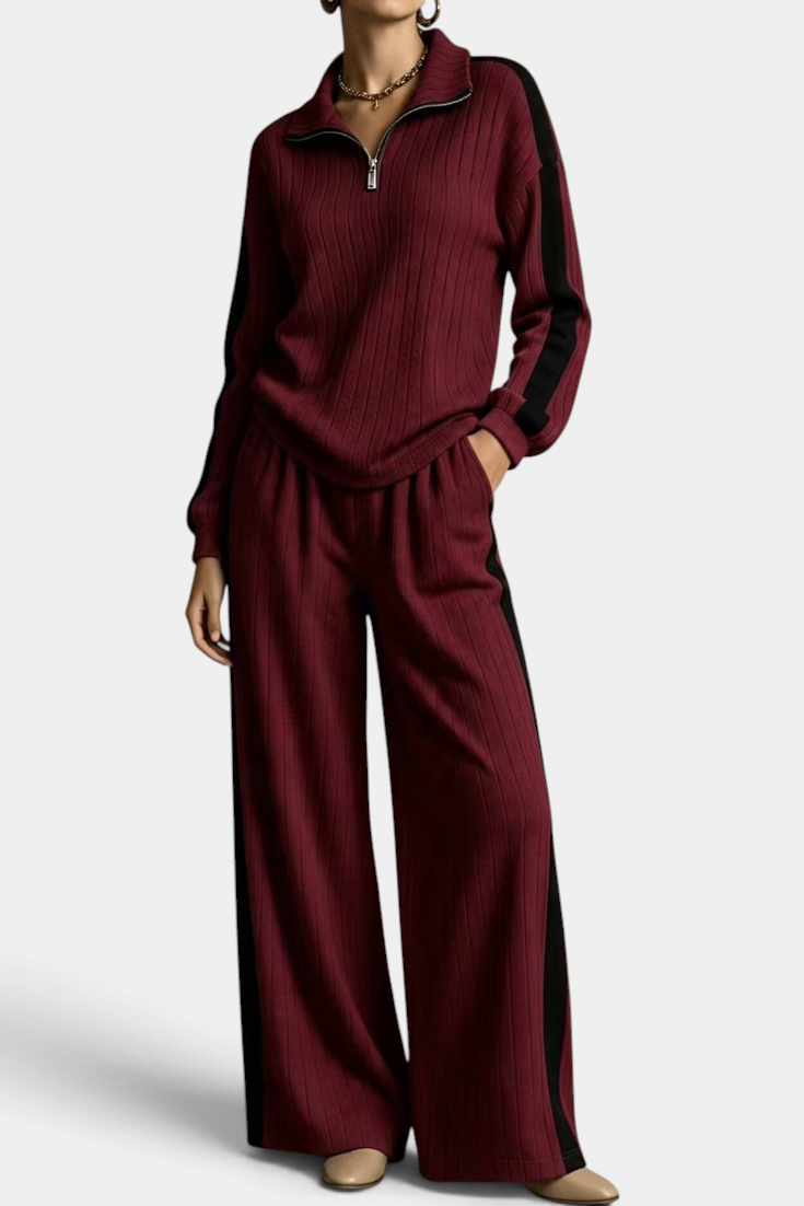Mahaute Cocoon burgundy ribbed knit lounge set with zip-up sweater and wide-leg trousers featuring contrast stripes.