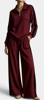 Mahaute Cocoon burgundy ribbed knit lounge set with zip-up sweater and wide-leg trousers featuring contrast stripes.