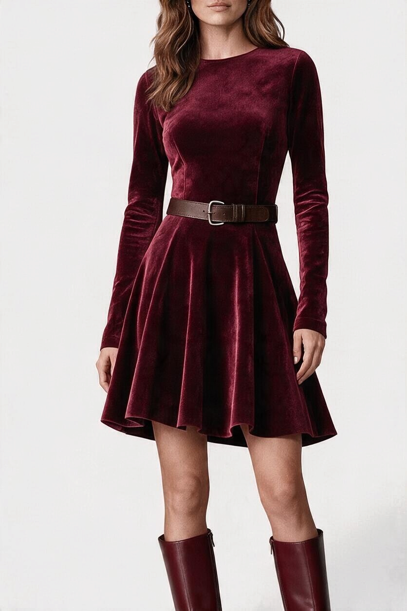Mahaute burgundy suede skater dress with long sleeves, round neck, and matching belt, worn with tall leather boots.