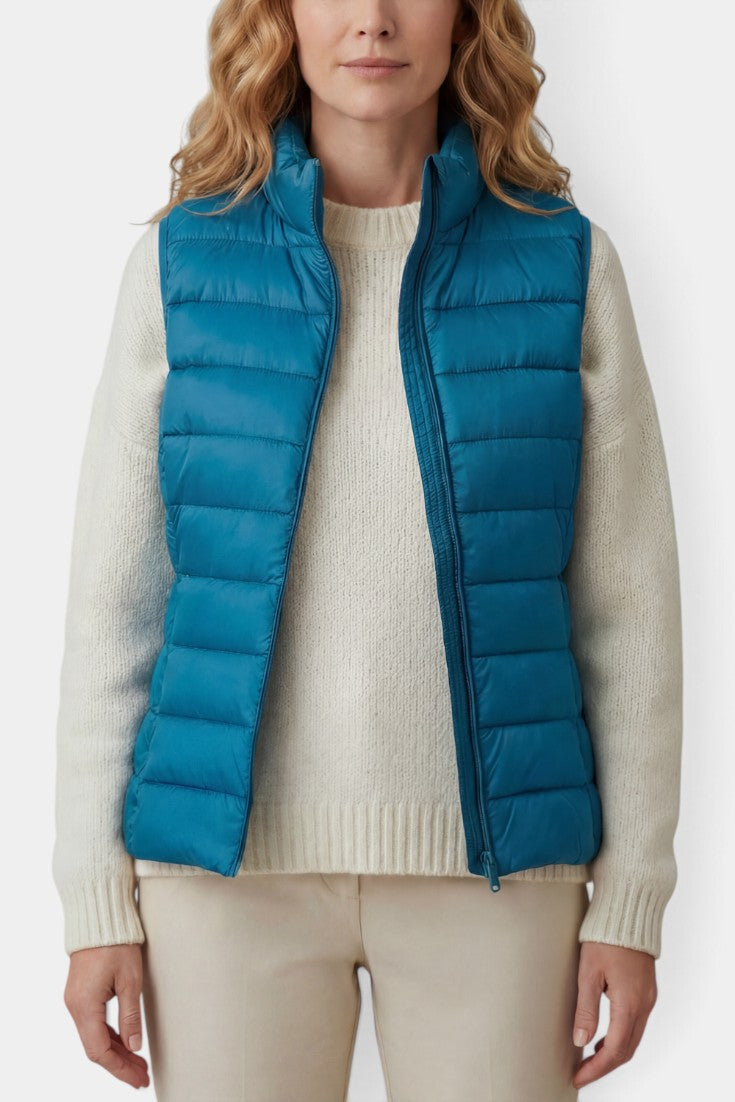 Gilet matelassé teal Mahaute Caeloria avec col montant et fermeture zippée, parfait pour le style et la chaleur.