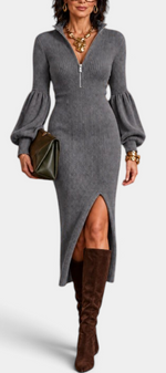 Mahaute Calyra grey ribbed knit midi dress with balloon sleeves, zip collar, and front slit worn with brown boots.