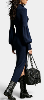 Mahaute Calyra navy blue ribbed midi dress with balloon sleeves, zip collar, and front slit, worn with western boots.