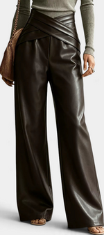 Mahaute Camellia wide-leg trousers in dark brown faux leather with a stylish crossover waist and front pleats.