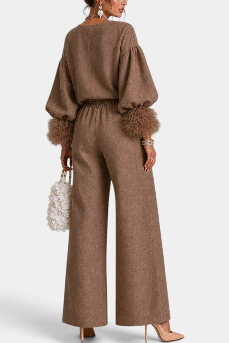 Mahaute Carrie brown two-piece set featuring a zip-up top with puff sleeves, ruffled cuffs, and wide-leg trousers.