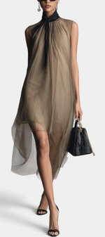 Mahaute Cecily midi dress in beige sheer voile with an asymmetrical hem and black lavalliere collar on a model.