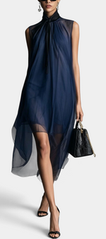 Mahaute Cecily navy blue asymmetrical midi dress in sheer voile with a lavalliere collar worn by a model.