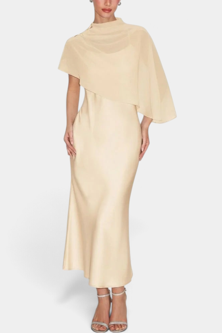 Mahaute midi satin dress in champagne featuring an elegant draped neckline and a flowing asymmetrical cape overlay.
