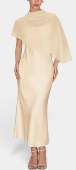 Mahaute midi satin dress in champagne featuring an elegant draped neckline and a flowing asymmetrical cape overlay.