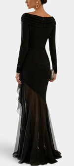 Mahaute Chantelle long black evening gown with draped neckline, long sleeves, and asymmetrical sheer ruffled skirt