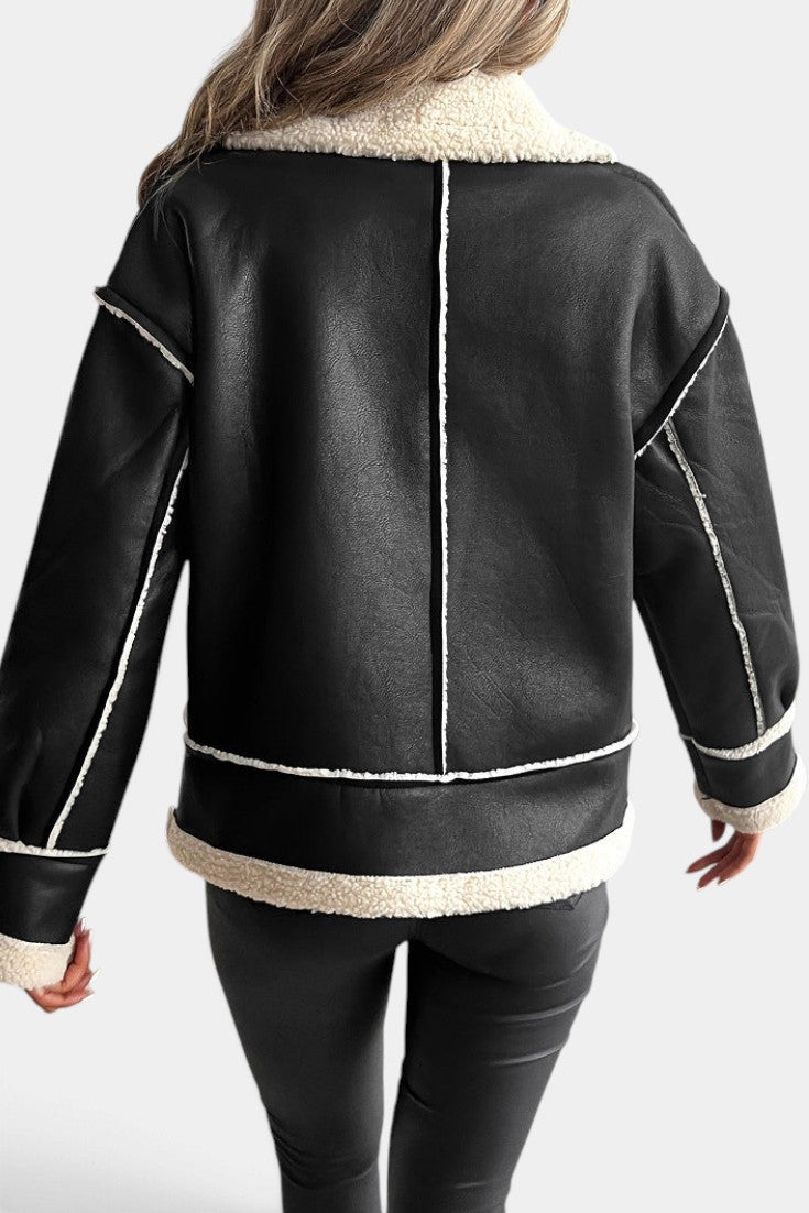 Back view of Mahaute Clarimonde black faux leather aviator jacket with white faux shearling trim and cropped fit.