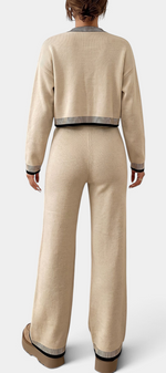 Back view of Mahaute Clemency beige knit lounge set with black and white striped trim on cardigan and wide-leg pants.