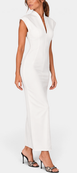 Mahaute Clorinde long white fitted dress with a high open collar, V-neckline, and structured shoulders on a model.