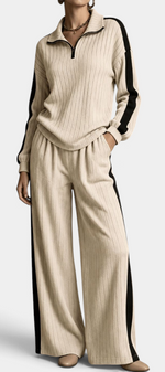 Mahaute Cocoon beige ribbed knit set with zip-up sweater and wide-leg trousers featuring black contrast side stripes.