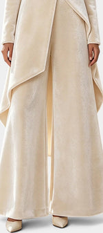 Mahaute Cosima cream velvet ensemble featuring an asymmetrical tunic with draped panels and wide-leg trousers.