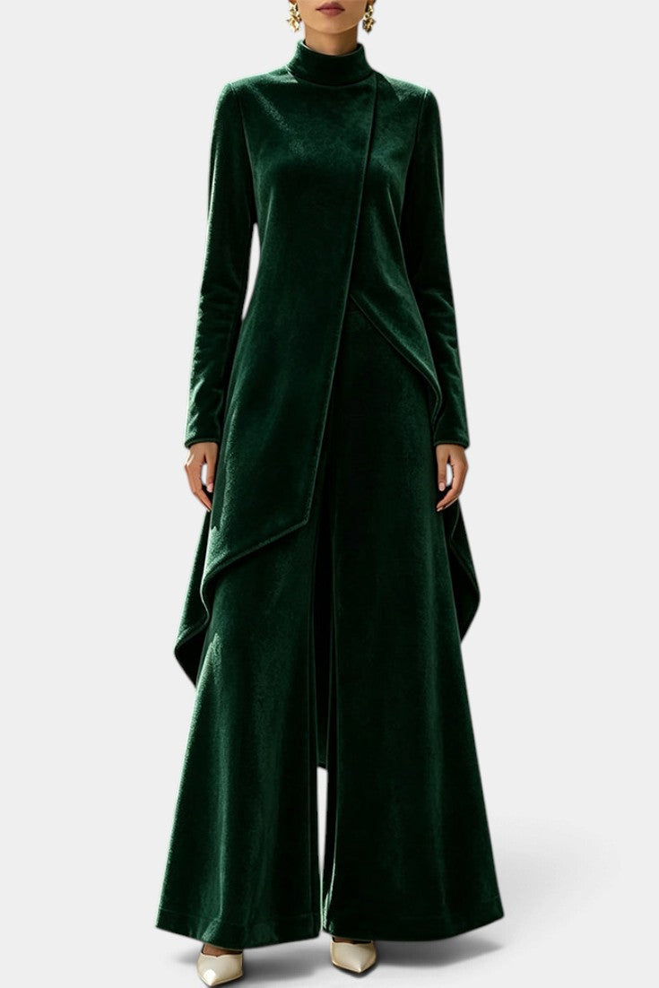 Mahaute Cosima dark green velvet ensemble with an asymmetrical tunic, high neck, and wide-leg trousers.