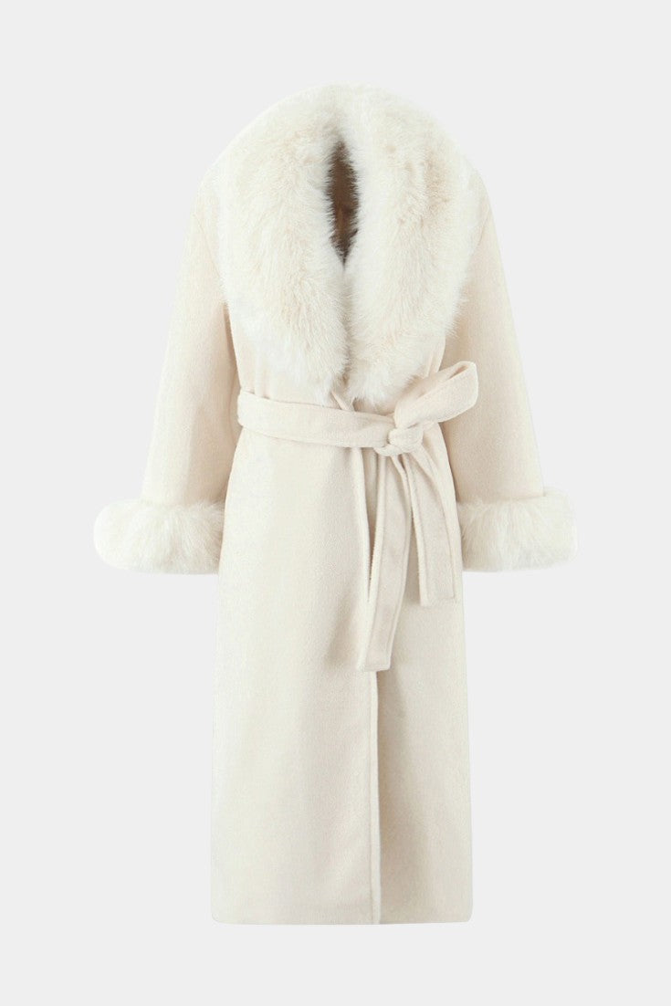 Mahaute long cream coat with a faux fur collar and cuffs, featuring a tie belt for a sophisticated winter silhouette.