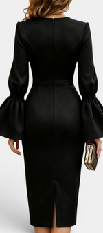 Back view of Mahaute Demelza black midi sheath dress with flared sleeves and a back slit on a model
