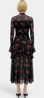 Robe longue Mahaute Églantine à imprimé roses, manches transparentes et volants, tissu fluide et élégant.