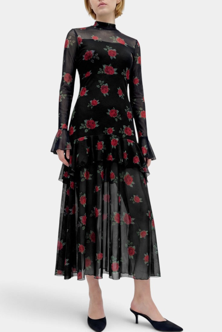 Robe longue Mahaute Églantine à imprimé roses, manches transparentes et volants, élégante et florale, portée sur mannequin.