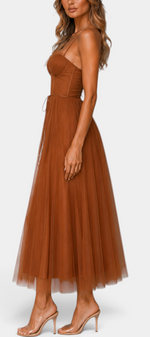Mahaute Eileen midi tulle dress in rust brown with a structured corset bodice and sweetheart neckline, side view.