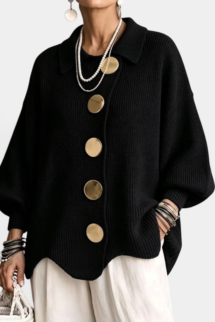 Mahaute Eleri black oversized knit cardigan with a shirt collar, balloon sleeves, and large gold buttons.