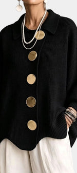 Mahaute Eleri black oversized knit cardigan with a shirt collar, balloon sleeves, and large gold buttons.