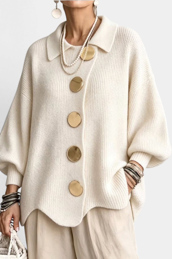 Mahaute Eleri cream knit oversized cardigan featuring a shirt collar, balloon sleeves, and large gold buttons.