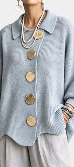 Mahaute Eleri light blue oversized knit cardigan with a shirt collar, balloon sleeves, and large gold buttons.