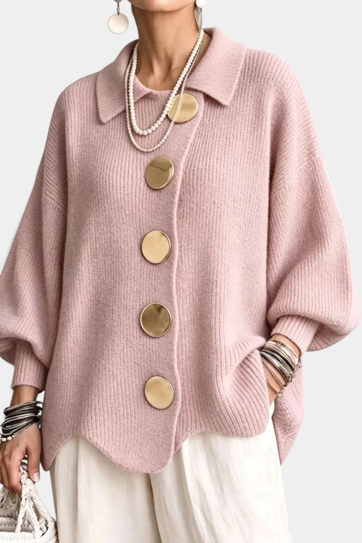 Mahaute Eleri oversized pink knit cardigan with a shirt collar, balloon sleeves, and large gold buttons.