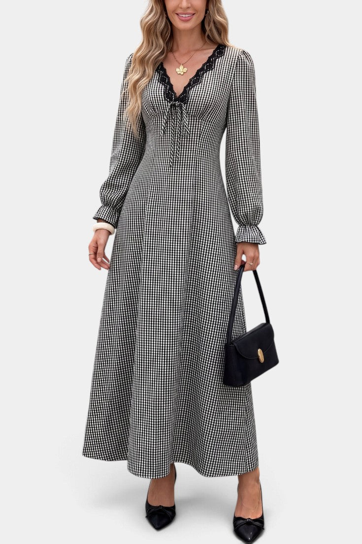 Mahaute Ethelinde long black and white gingham dress with V-neck lace trim and long puff sleeves on a model