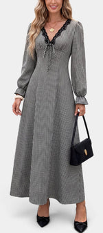 Mahaute Ethelinde long black and white gingham dress with V-neck lace trim and long puff sleeves on a model