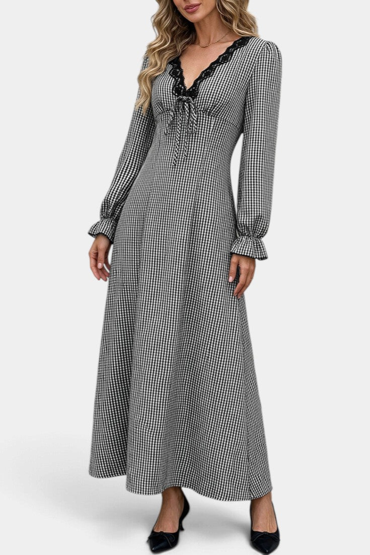 Mahaute Ethelinde long black and white gingham dress with V-neck lace trim and long puff sleeves on a model