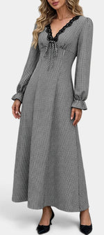 Mahaute Ethelinde long black and white gingham dress with V-neck lace trim and long puff sleeves on a model