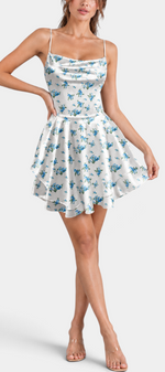 Mahaute short satin dress with blue floral print, cowl neckline, and layered ruffled skirt on a model