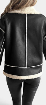 Back view of Mahaute Flynn short black faux suede jacket with cream faux fur collar and contrasting white trim