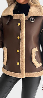 Mahaute Flynn brown faux suede short coat with cream faux fur collar, gold buttons, and contrast trim details.