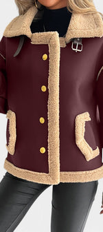 Mahaute Flynn burgundy faux suede short coat with cream faux fur collar, gold buttons, and contrast trim details.