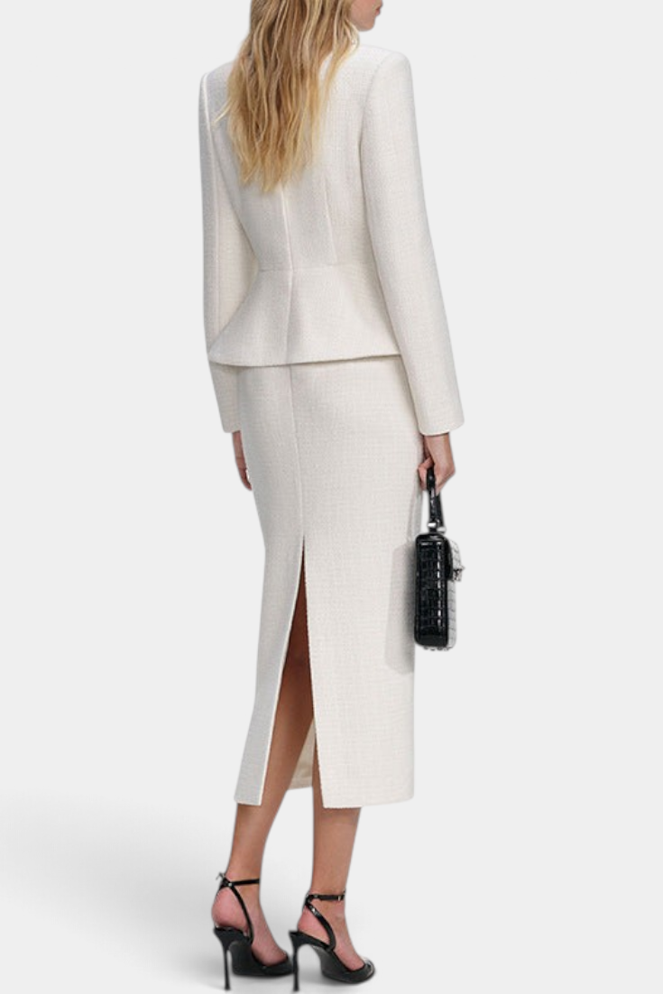 Back view of Mahaute Gergana cream structured peplum jacket and midi skirt with a back slit on a model