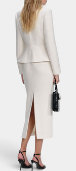 Back view of Mahaute Gergana cream structured peplum jacket and midi skirt with a back slit on a model