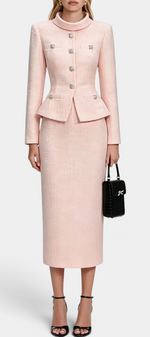 Mahaute Gergana pink tweed skirt suit with a structured peplum jacket, high collar, and sparkling jewel buttons.