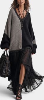 Mahaute Gingelle long two-tone knit and voile dress with V-neck, lace trim, and flowing skirt worn by a model.