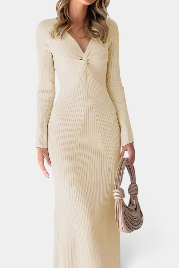 Mahaute Giorgina long cream ribbed knit dress with V-neck and twisted bust detail worn by a model