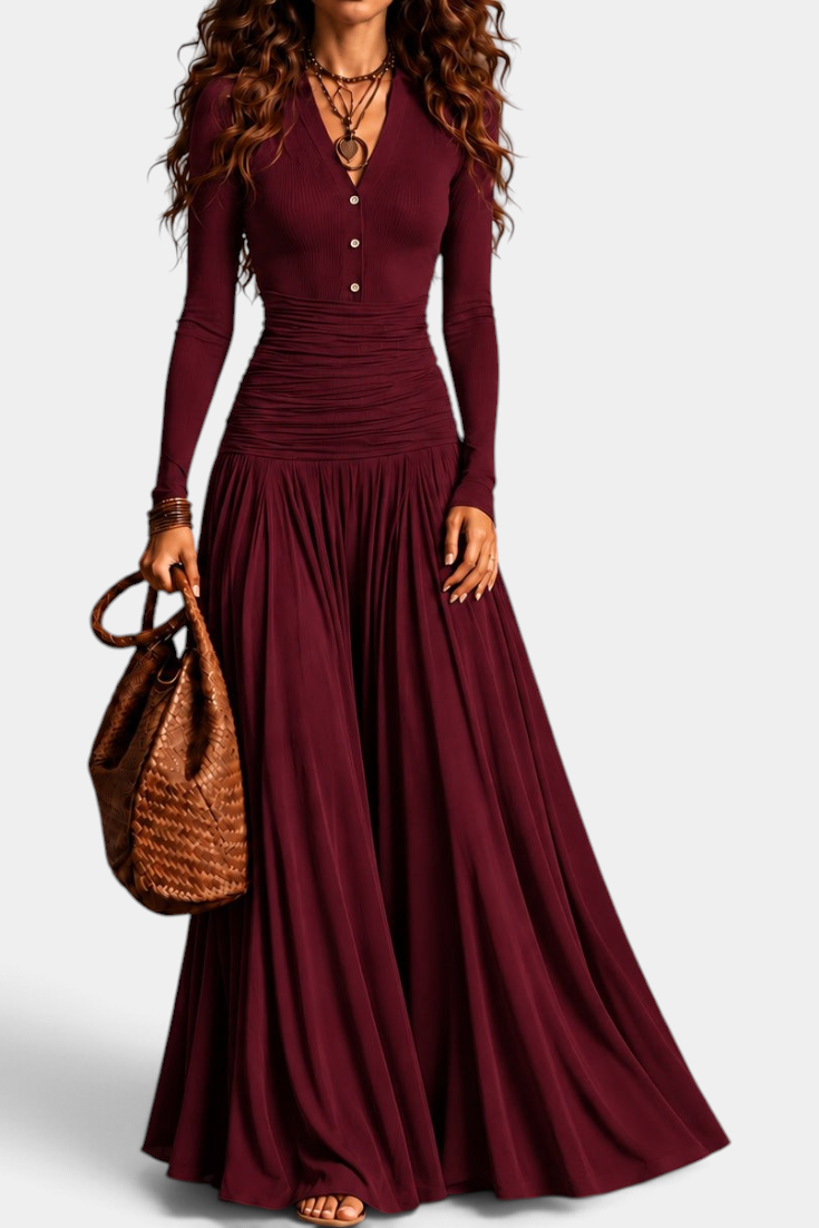 Mahaute Gracia long burgundy dress with V-neck, buttoned bodice, ruched waist, and flowing skirt on a model.