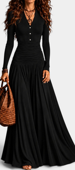 Mahaute Gracia long black dress with V-neck, buttoned bodice, ruched waist, and flowing skirt on a model